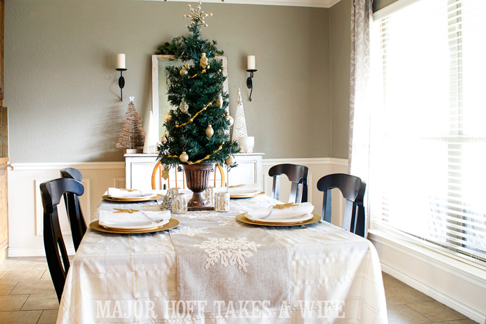 Use a table top tree to make a simple centerpiece. A delightful Dining Room Holiday Tour. See how Mrs Major Hoff decorates for Christmas. The tour features table decorations, dining room decorating ideas, place settings and an idea for  homemade Christmas gift that can be personalized for your holiday guests. This post is part of the Home For The Holidays Blog Tour.